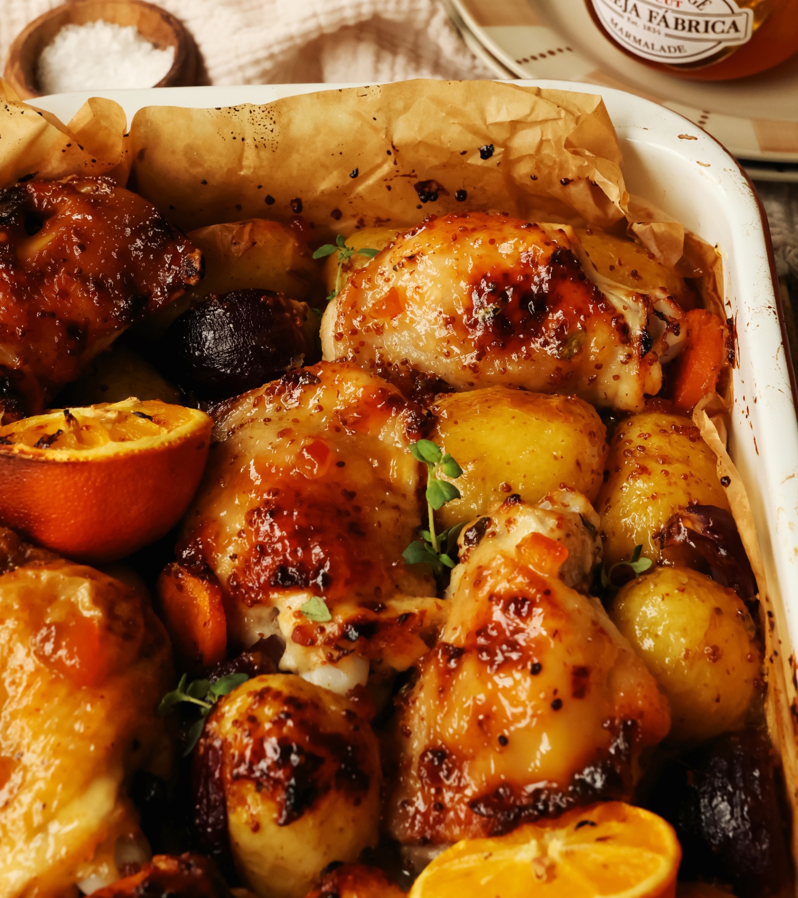 a close up of sticky marmalade chicken traybake