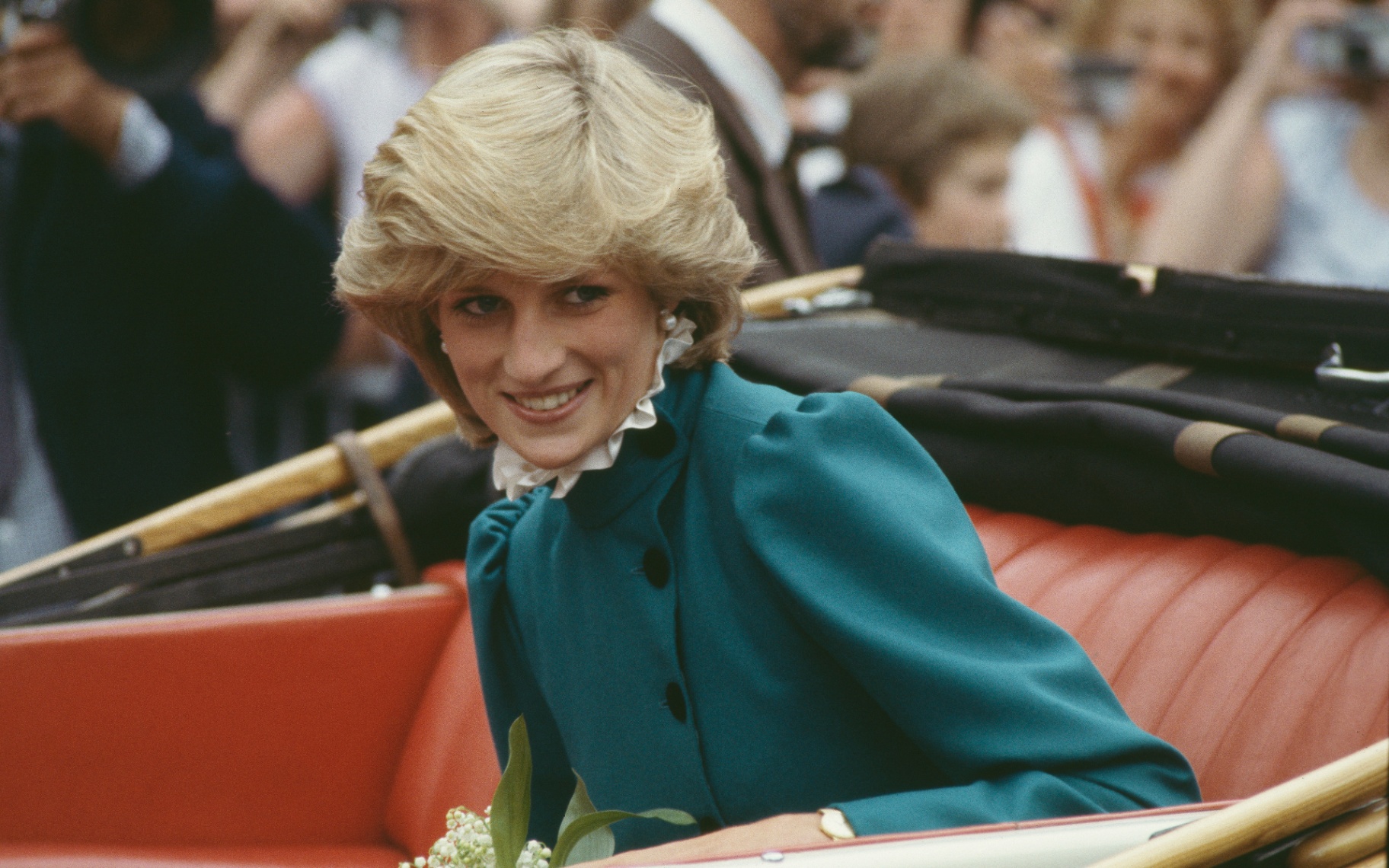 princess diana in 1983 wearing a teal dress in a royal carriage