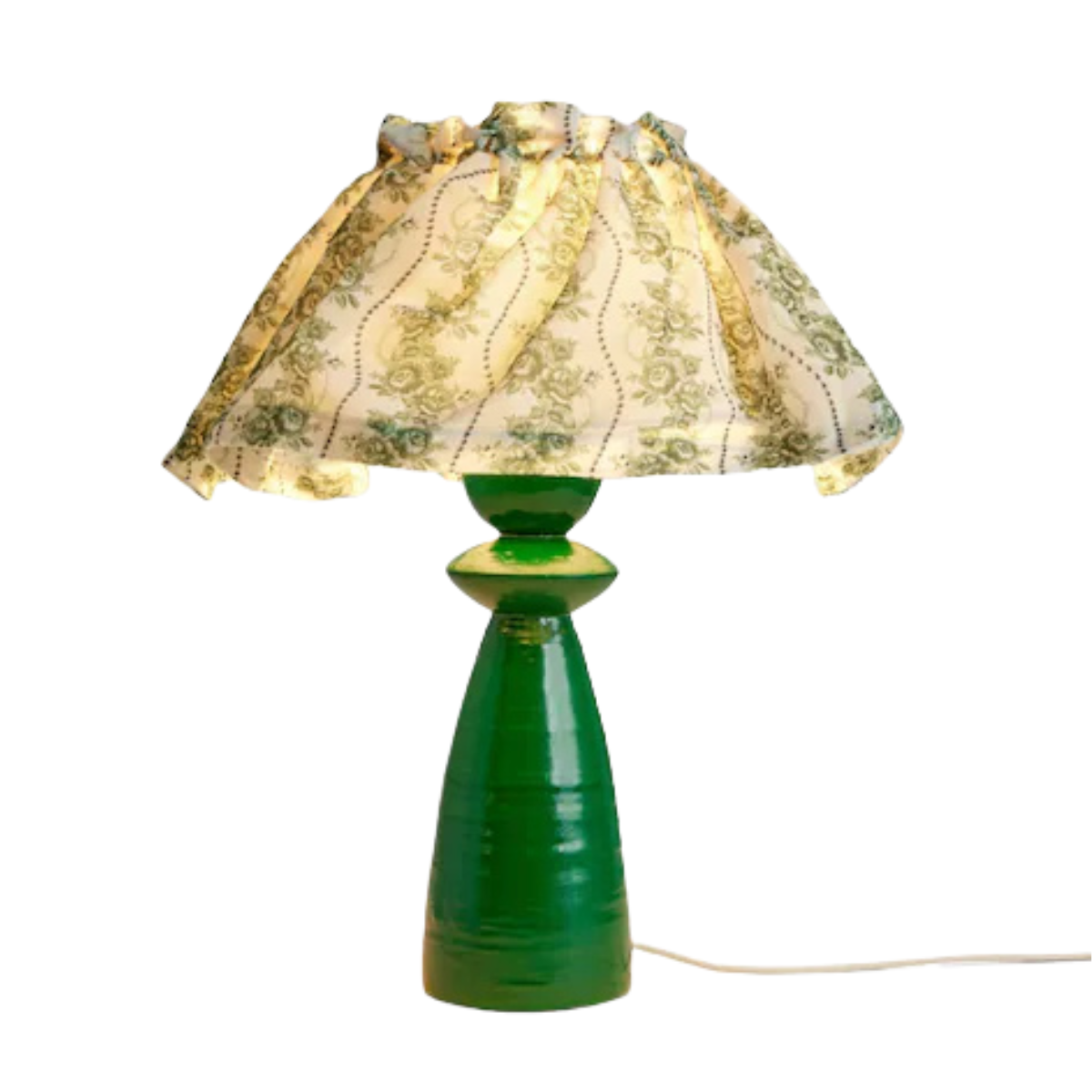 a green table lamp with a white and green rose print fabric shade