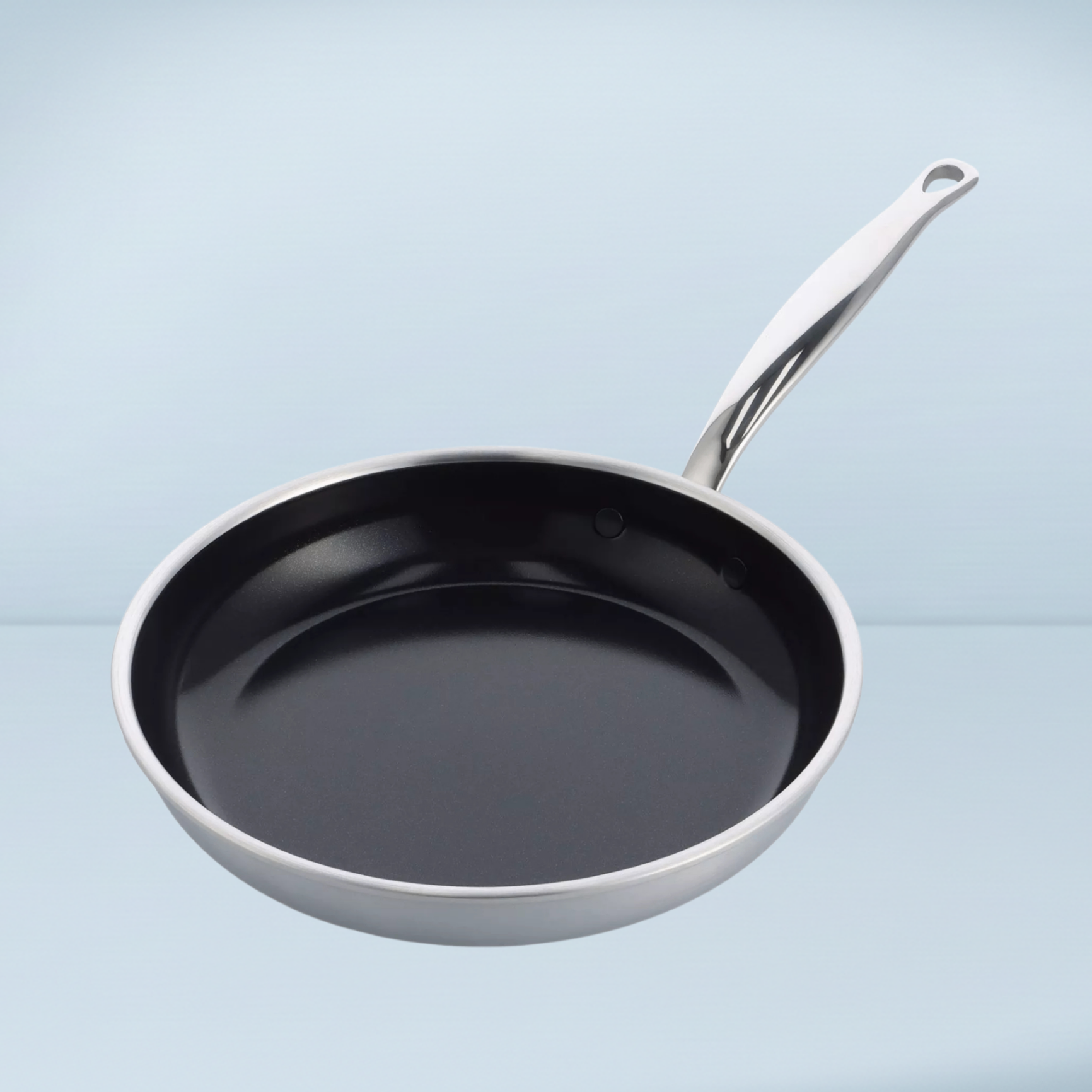 a silver frying pan with a black interior