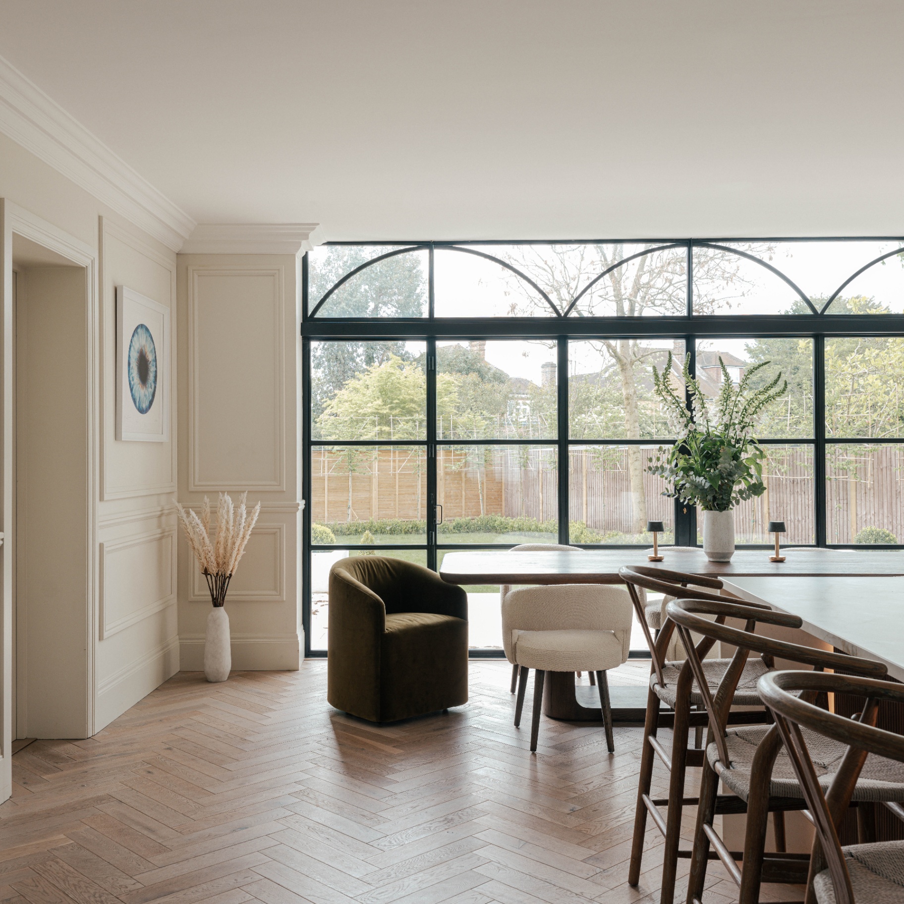 inside David Gandy's richmond home pictured the light kitchen and breakfast dining table with vast floor to ceiling windows looking out to the garden