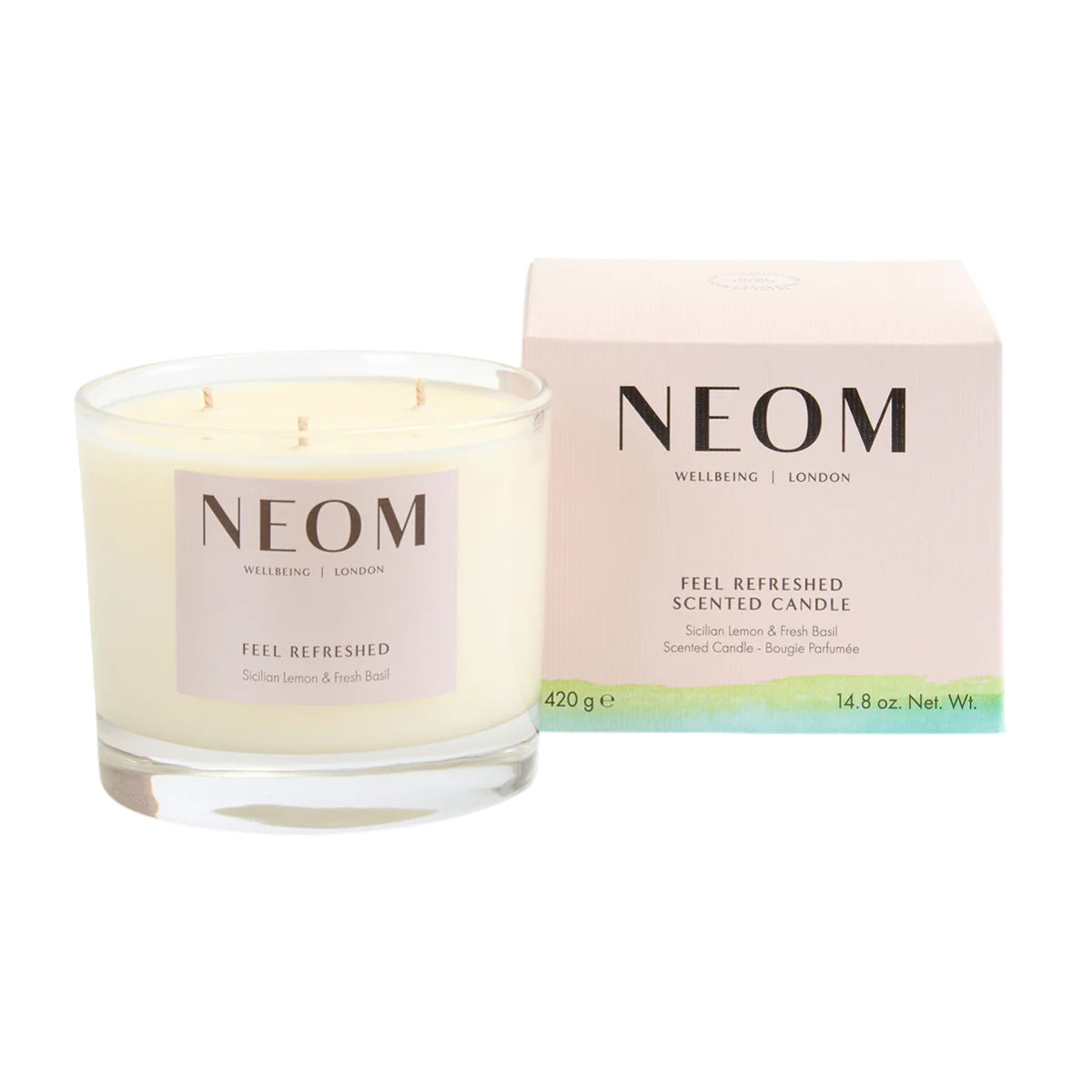 NEOM FEEL REDRESHED SCENTED CANDLE NEXT TO THE PACKAGING WITH A GREEN AND BLUE STRIPE
