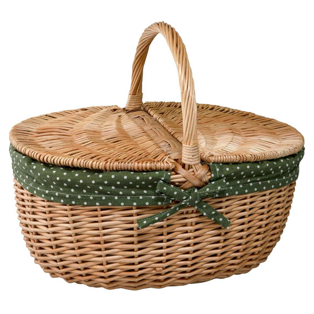an oval wicker picnic basket with a dark green and white polka dot lining