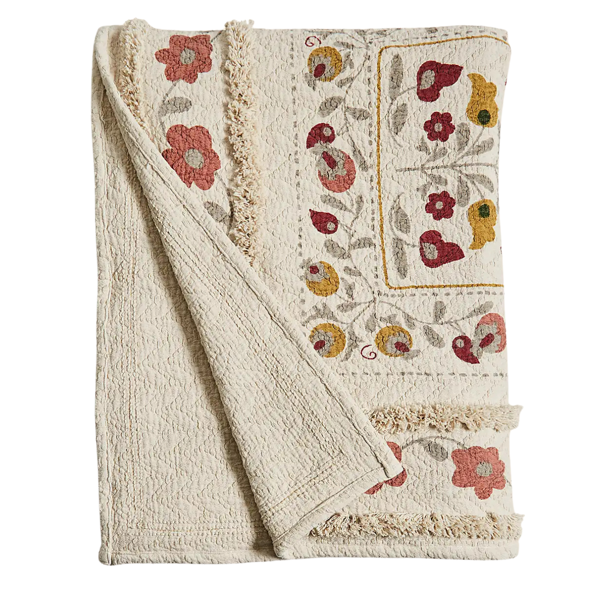a cream tufted throw with yellow red and pink flowers