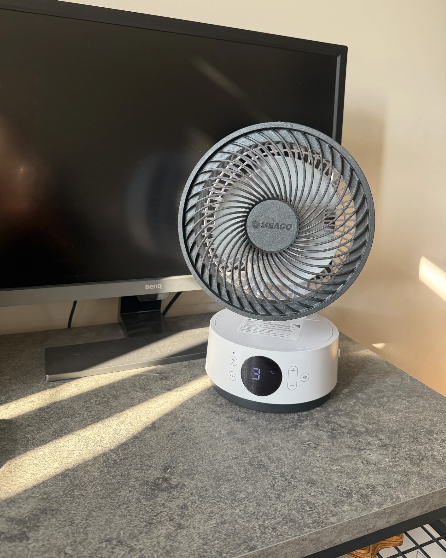 meaco desk fan on a grey desk in front of a black monitor