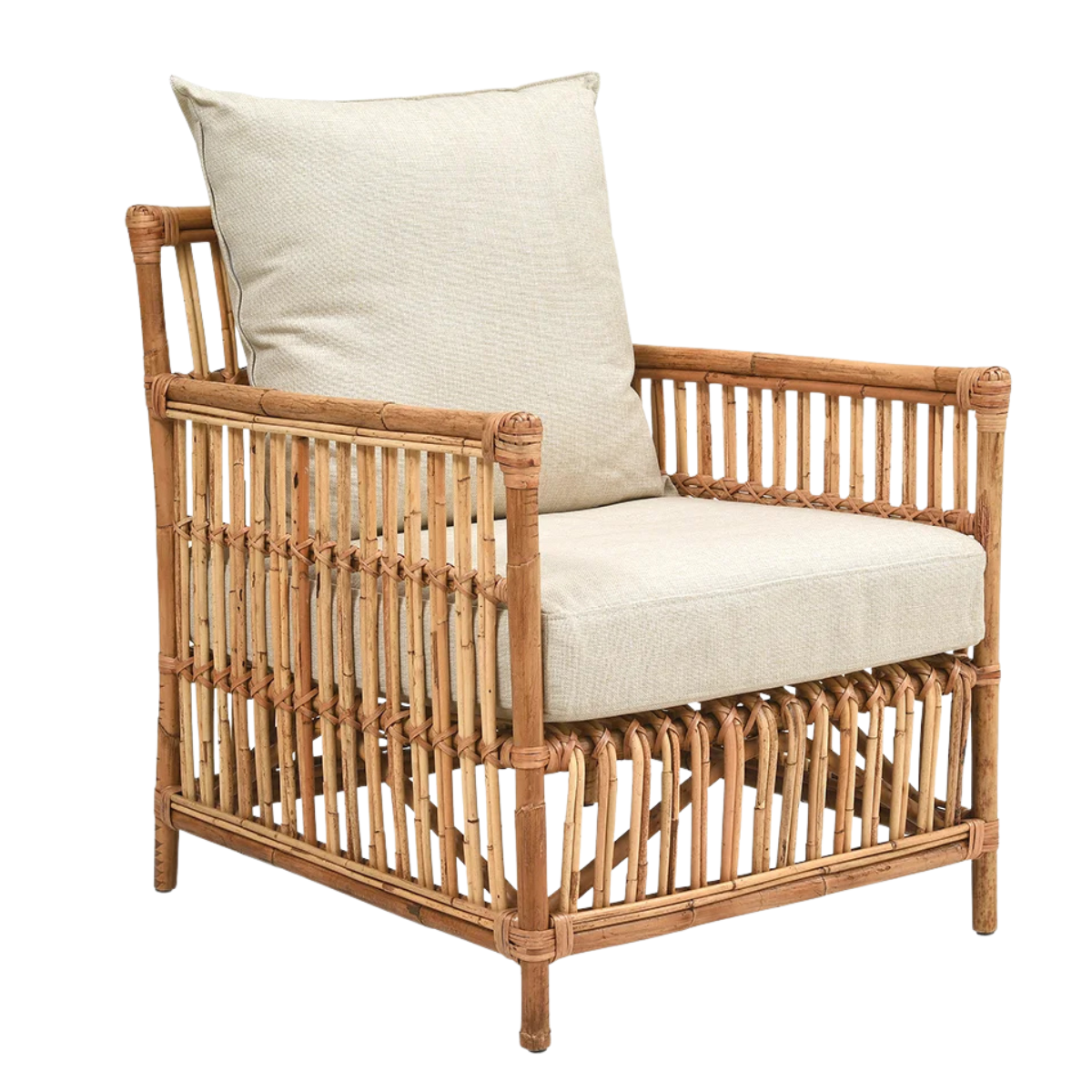 a rattan armchair with cream seat cushions