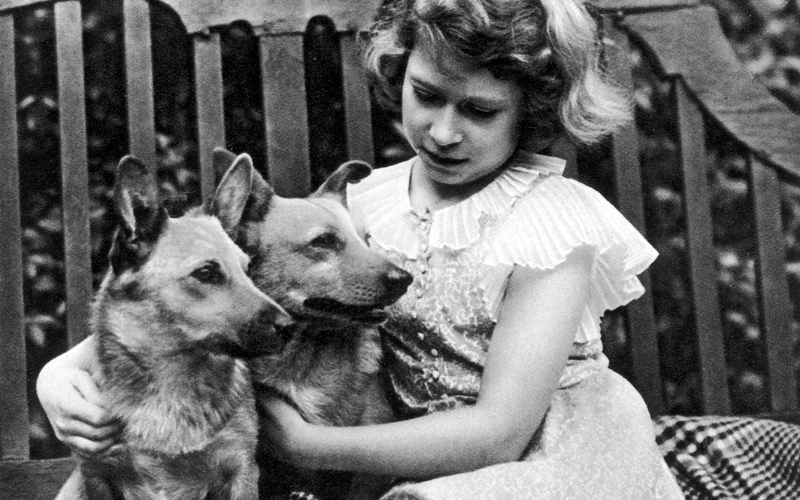 Princess Elizabeth of York (now Queen Elizabeth II) taken at the York's London residence, 145, Piccadilly in 1936 with two of her corgi
