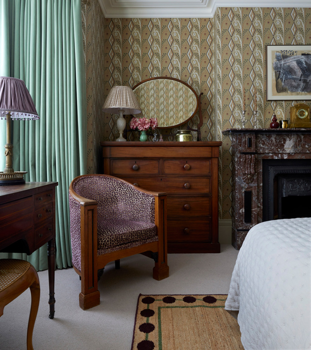 a bedroom with dark wooden chair and dresser