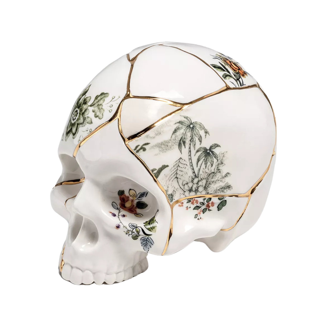 a white porcelain skull ornament with floral and gold details