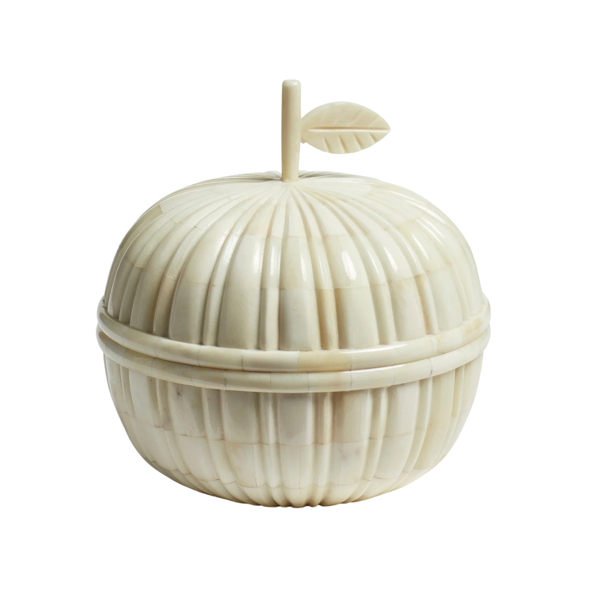 a white trinket box in the shape of an apple