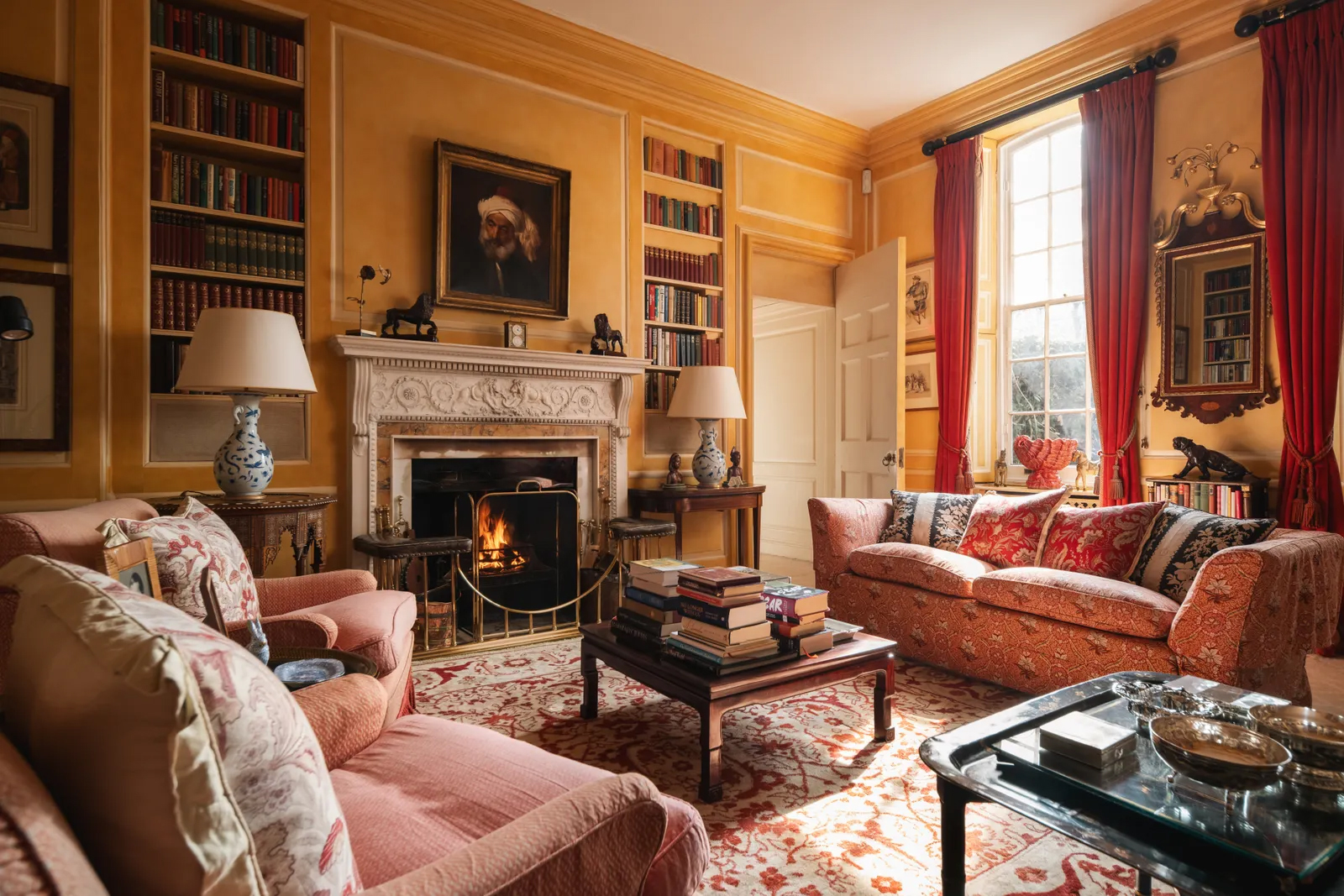 the grand drawing room of Ormeley Lodge, Richmond, with yellow walls and red velvet curtains