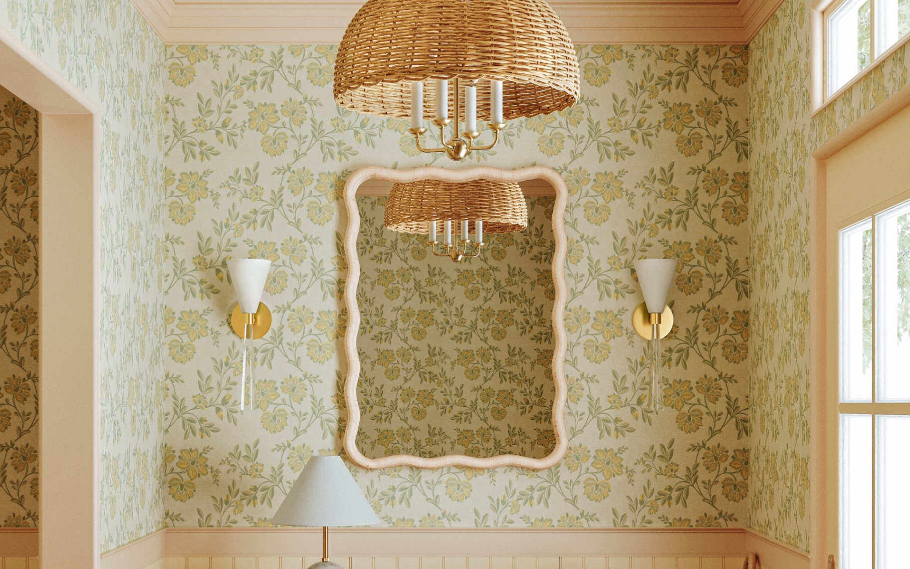 a room with cream and green floral wallpaper, a large rattan pendant chandelier light, two white and gold wall sconces either side of a cream wavy mirror and the top of a white table lamp