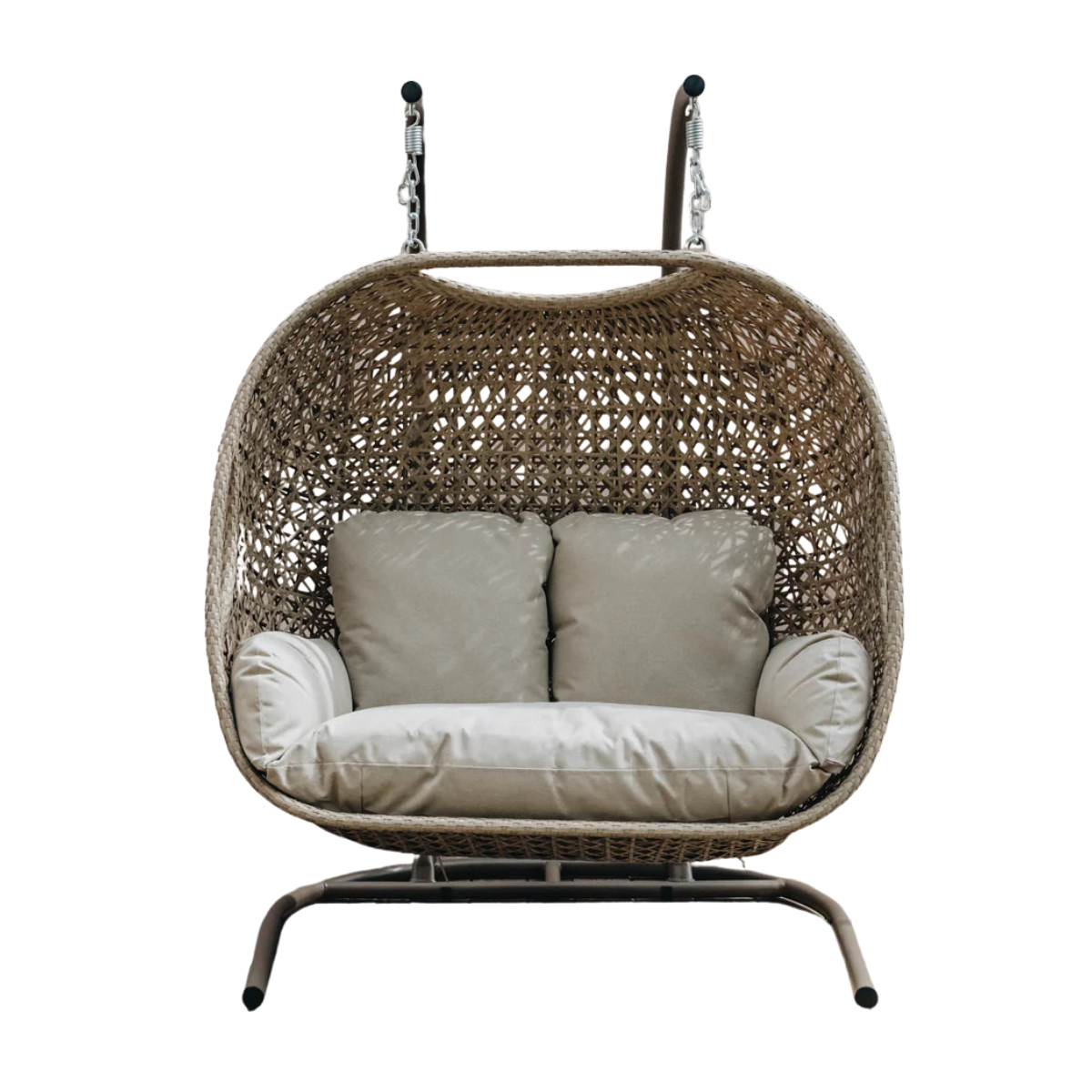 a beige rattan hanging egg chair with beige seat cushions