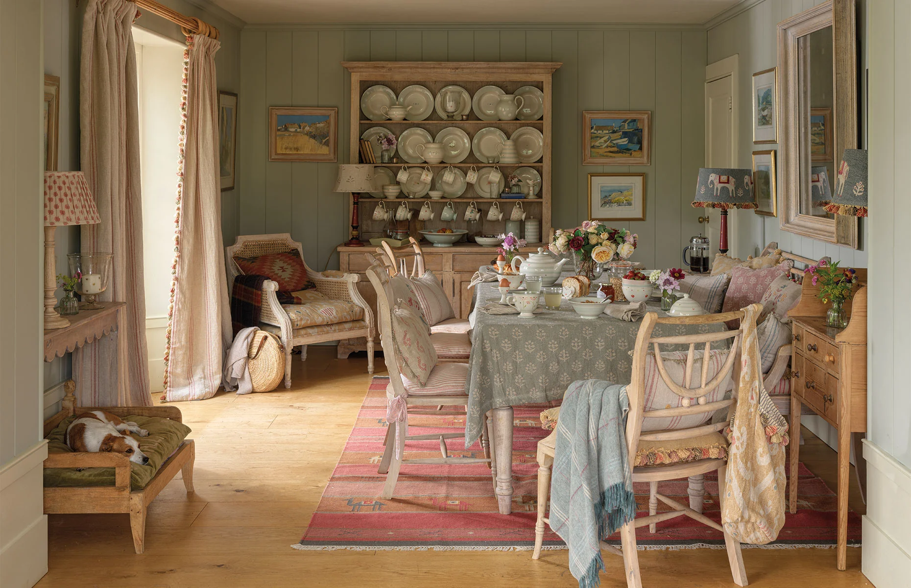 a beautiful dining room pictured with a dog cooling down in the corner