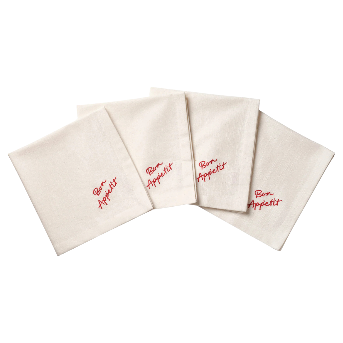 a set of 4 white napkins with bon appetite embroidery