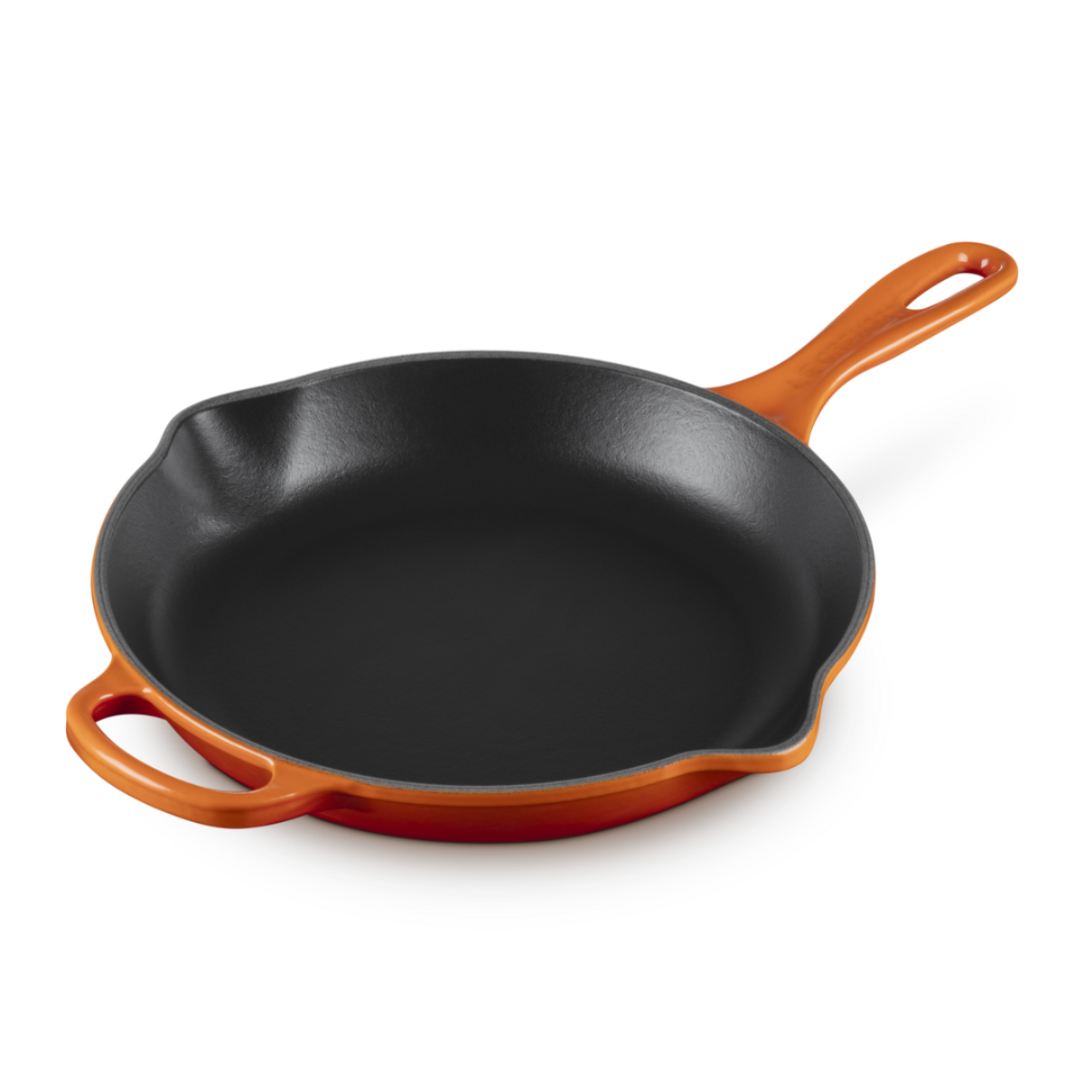 an orange cast iron skillet on a white background