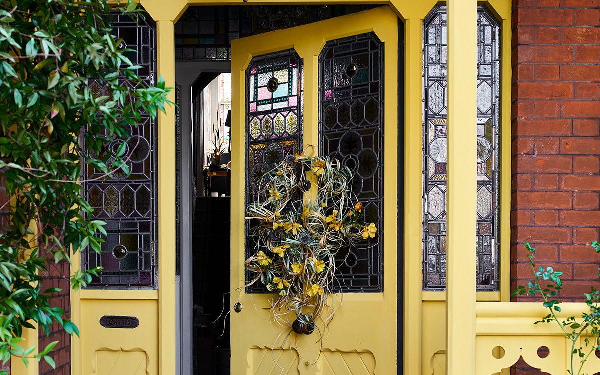 yellow door with yellow easter wreath