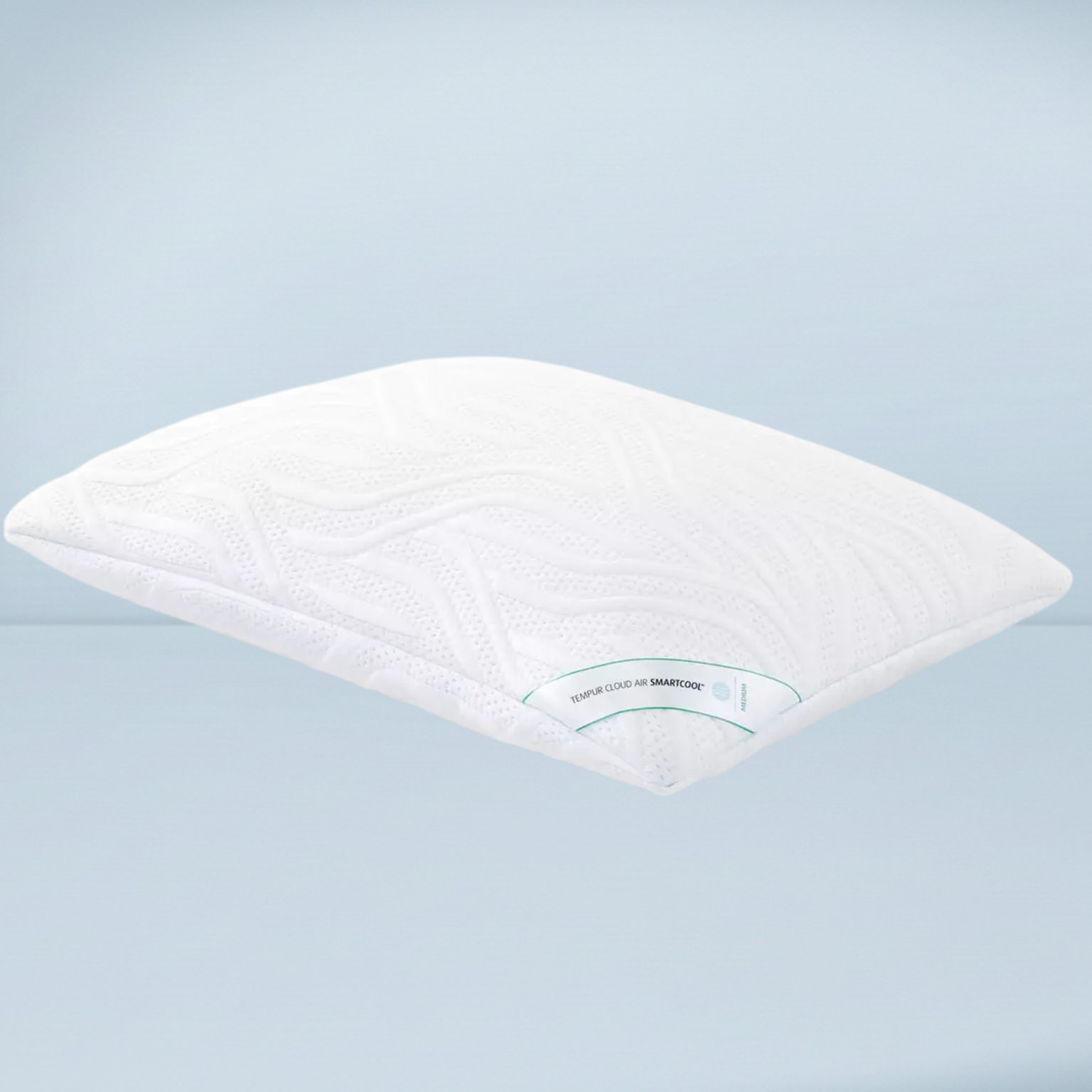a white memory foam tempur pillow on a pale blue background