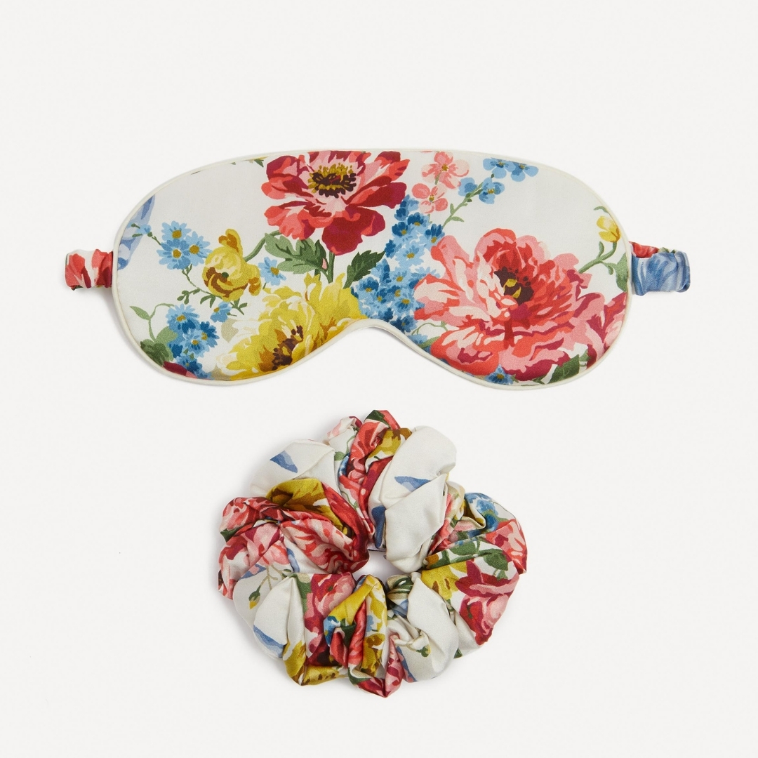 Liberty bridgerton Bow Bouquet Silk Eye Mask and Scrunchie Set pictured on a grey background