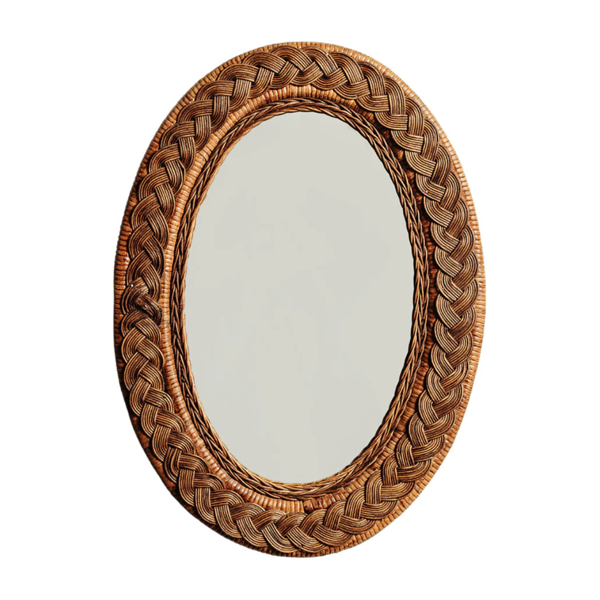 a large oval rattan and teak mirror with braided detail
