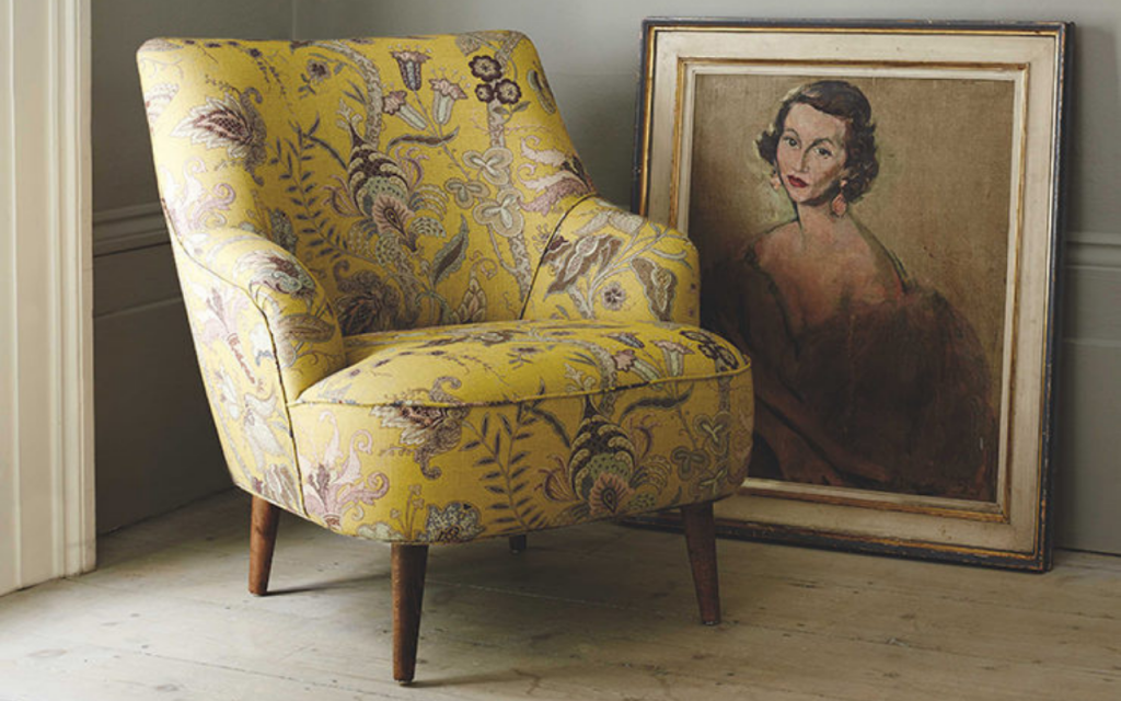 Reupholstering a vintage armchair with a golden print makes the seat an inviting spectacle. Uhura fabric, £59.90 a metre, Linwood