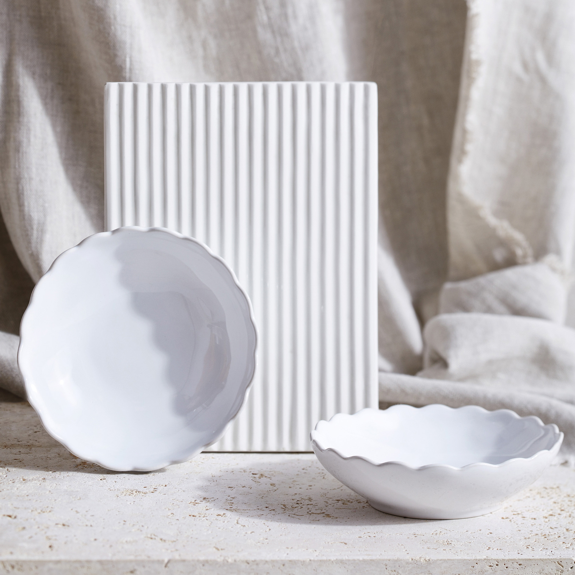 2 white bowls with a scallop rim