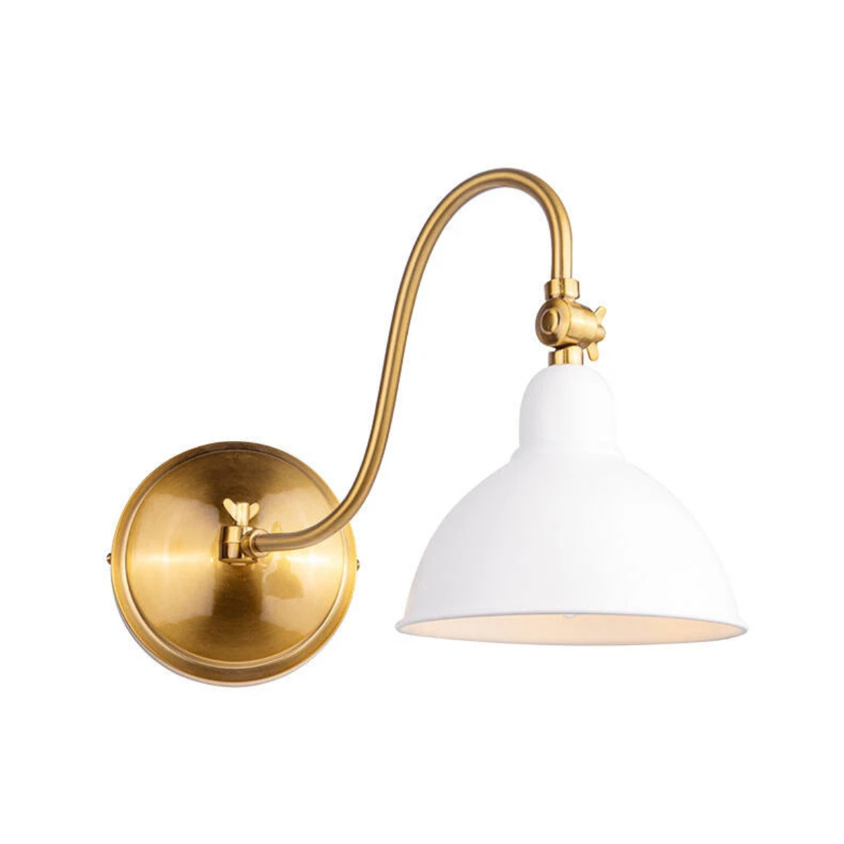 a gold sconce with a white shade