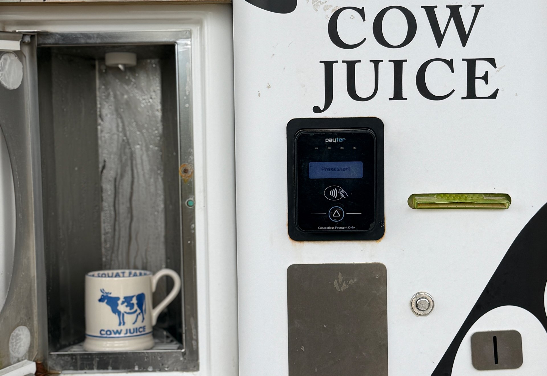 diddly squat farm cow juice machine with the emma bridgewater cow juice mug under the machine