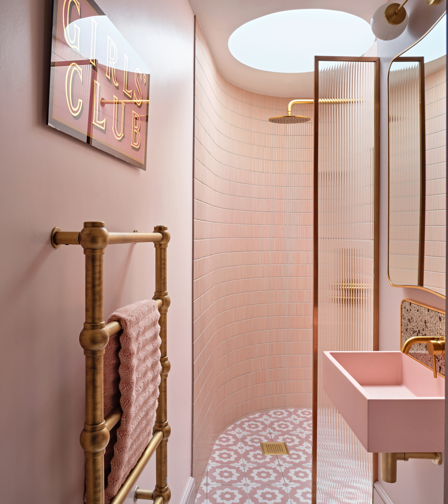 pink en suite bathroom with sky light