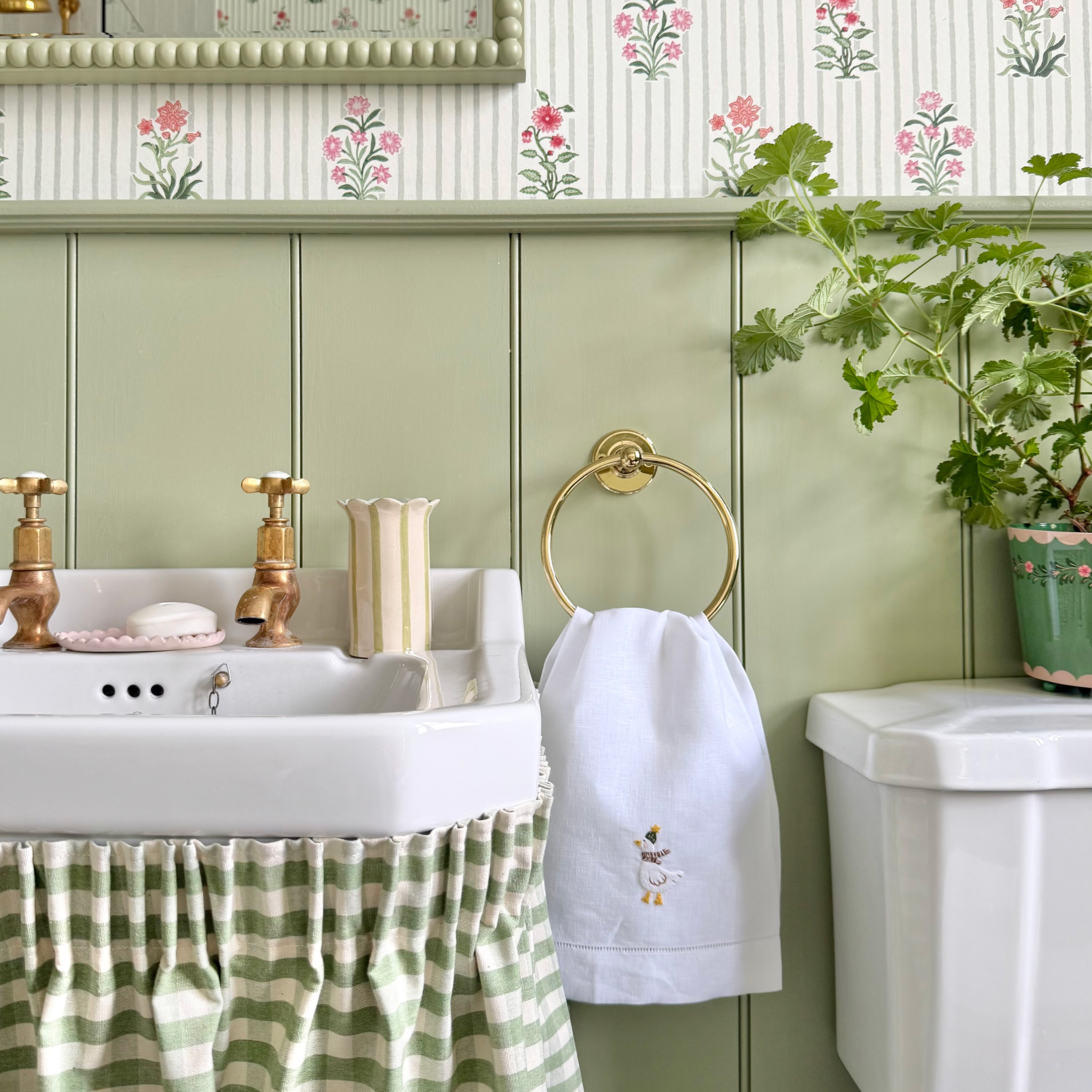 bathroom with gingham under sink skirt and floral wallpaper