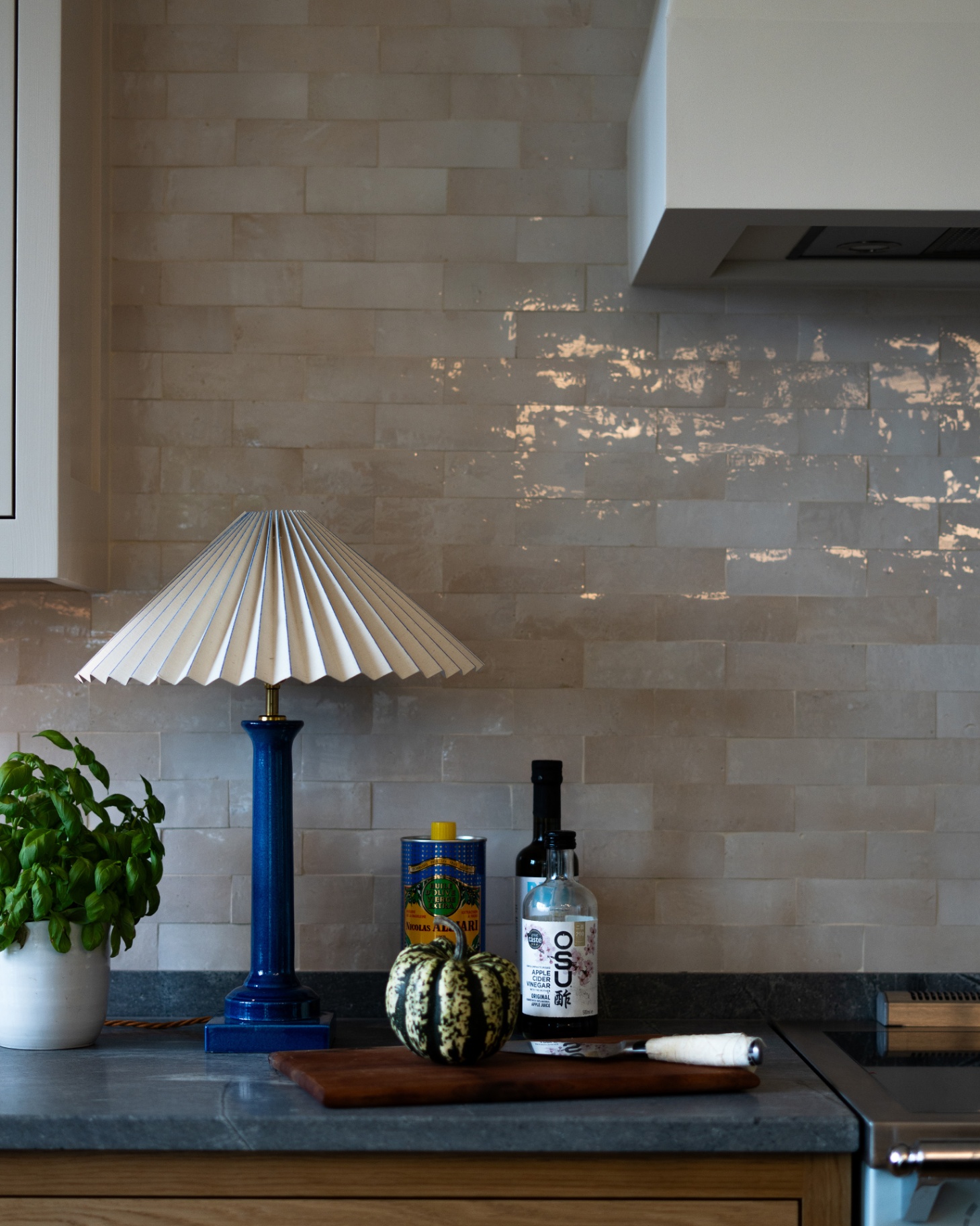 pringle and pringle kitchen corner with a neutral tiled wall and splashback, a dark grey worktops