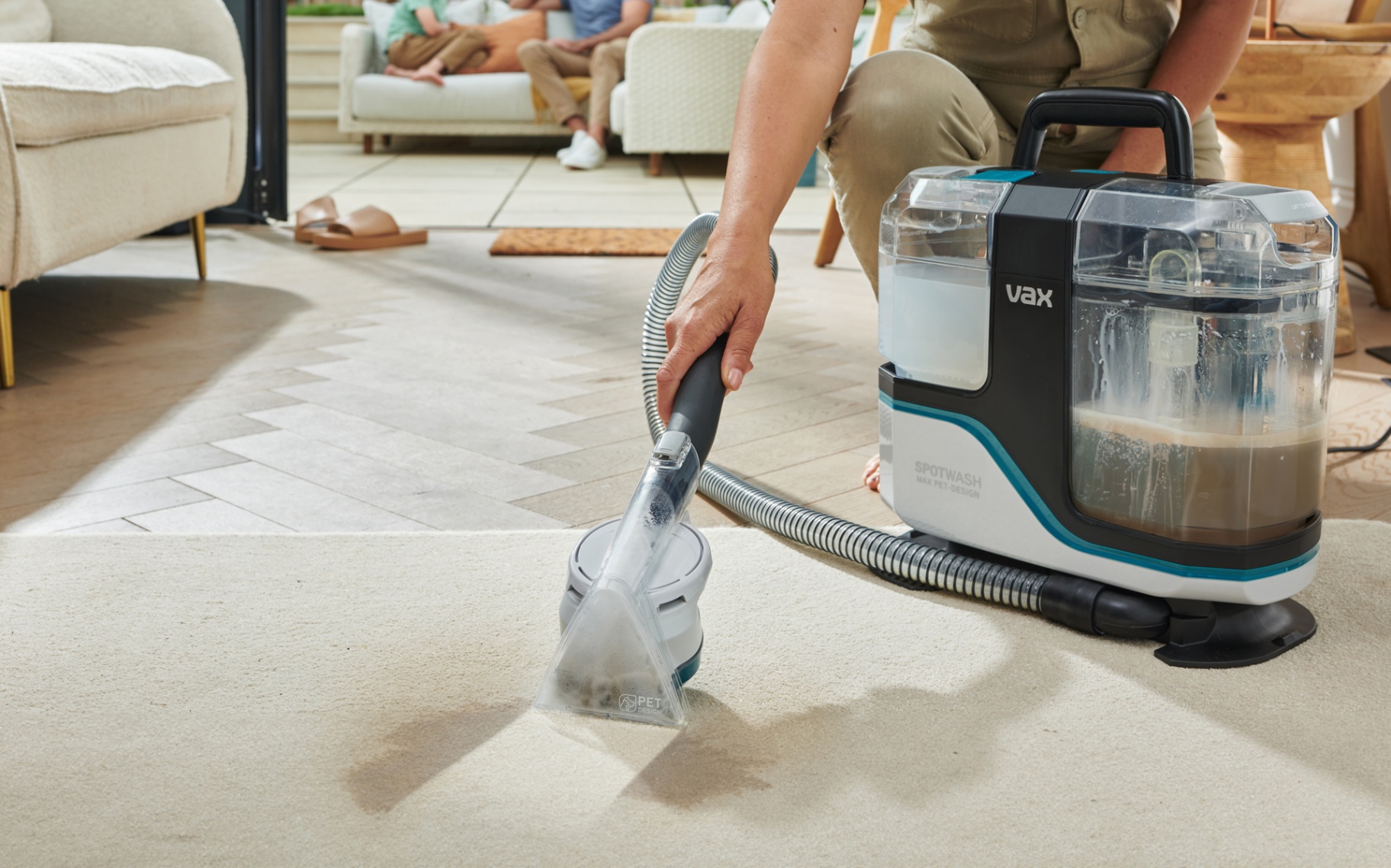 a vax spot washer being used to clean a cream carpet