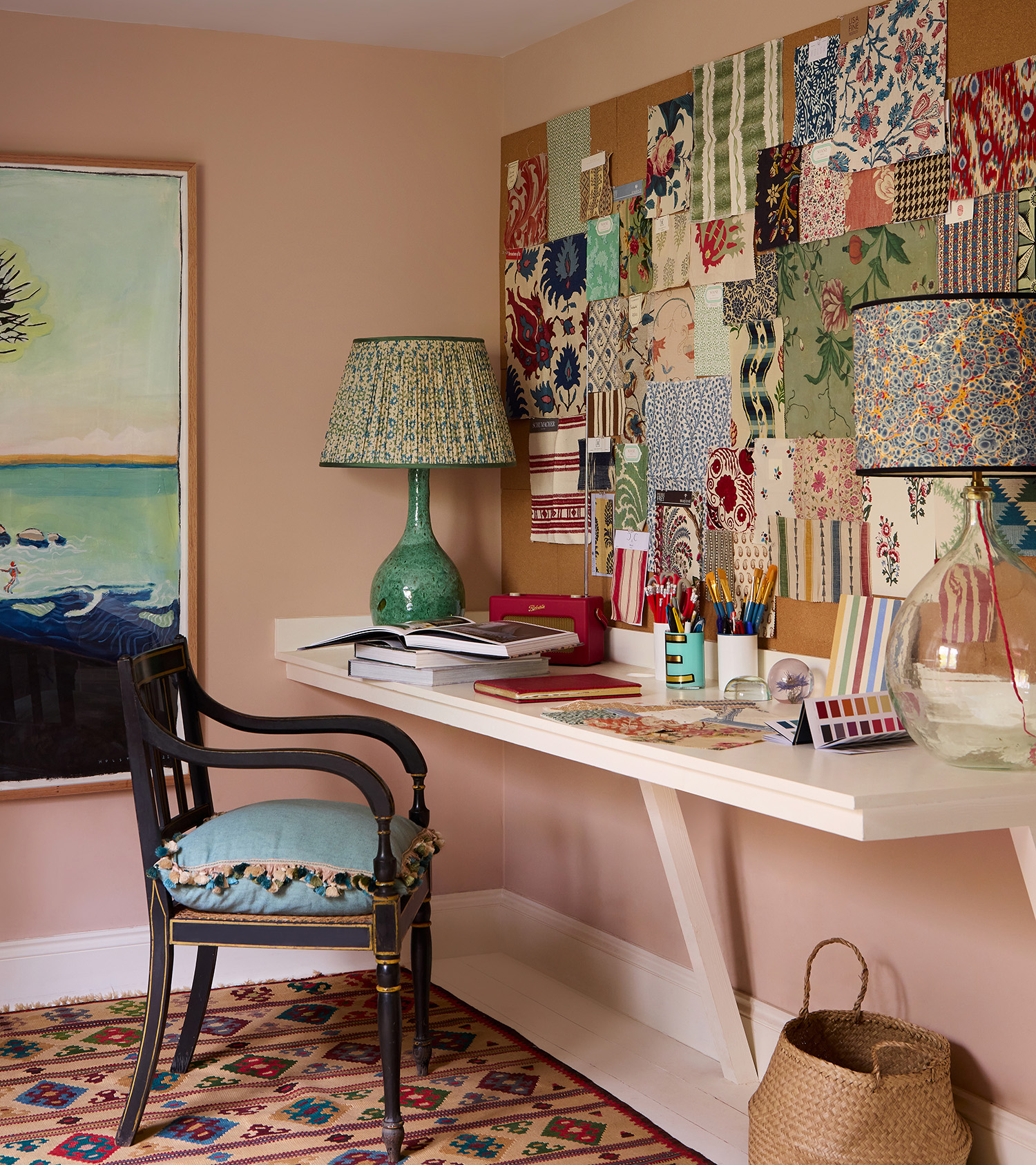 pink study with fabric samples on the wall