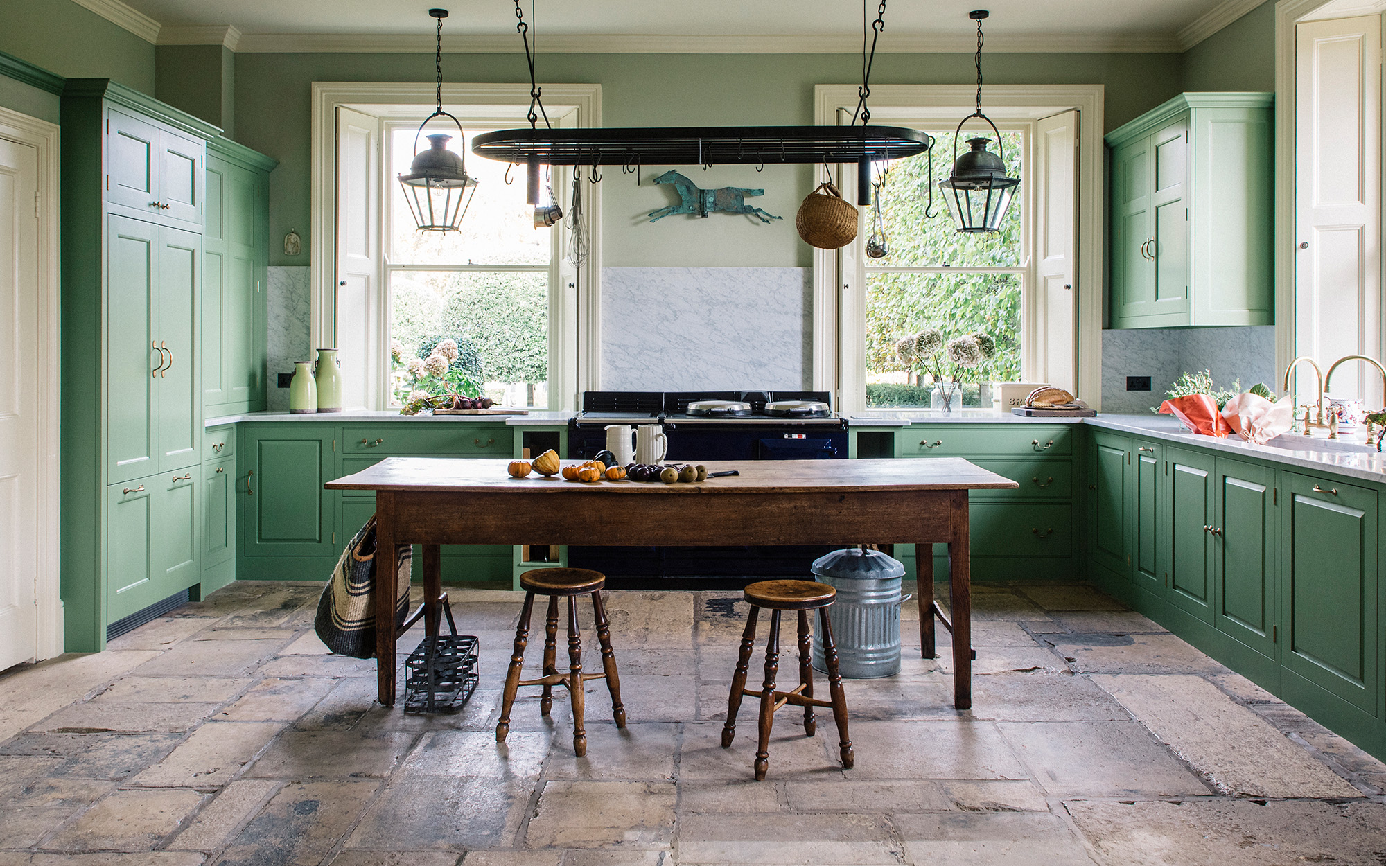 green kitchen with brown flagstone flooring