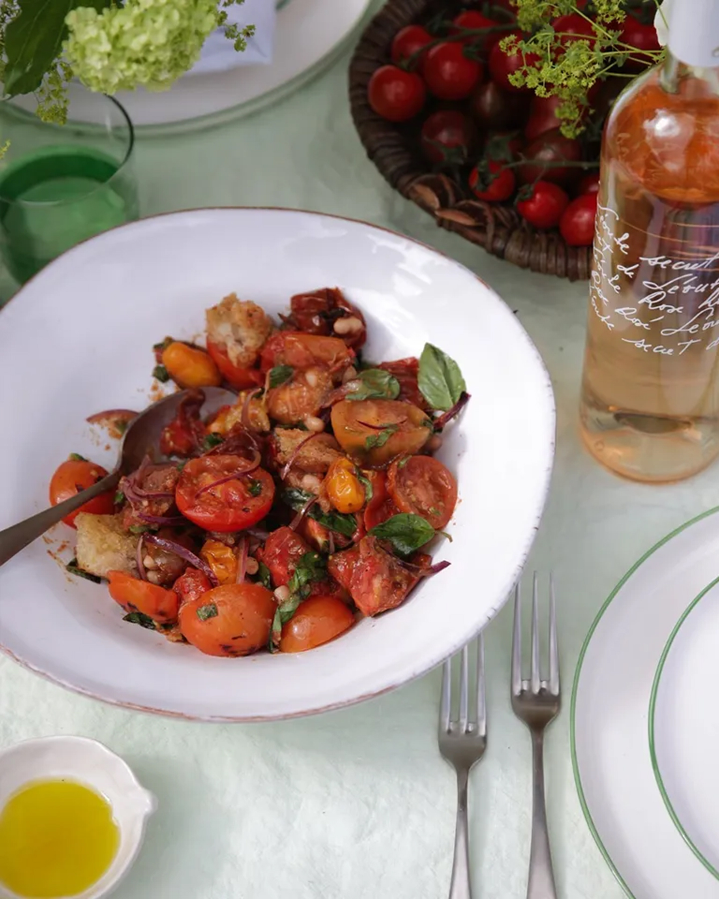 a panzanella salad with heritage tomatoes in a white bowl