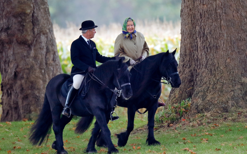 Queen Elizabeth II, accompanied by her Stud Groom Terry Pendry, seen horse riding in the grounds of Windsor Castle on October 18, 2008 in Windsor,