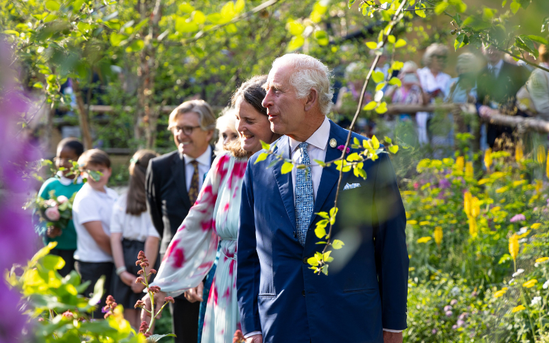 The King visiting Chelsea Flower Show in 2024 he is a white man with grey hair wearing a blue suit